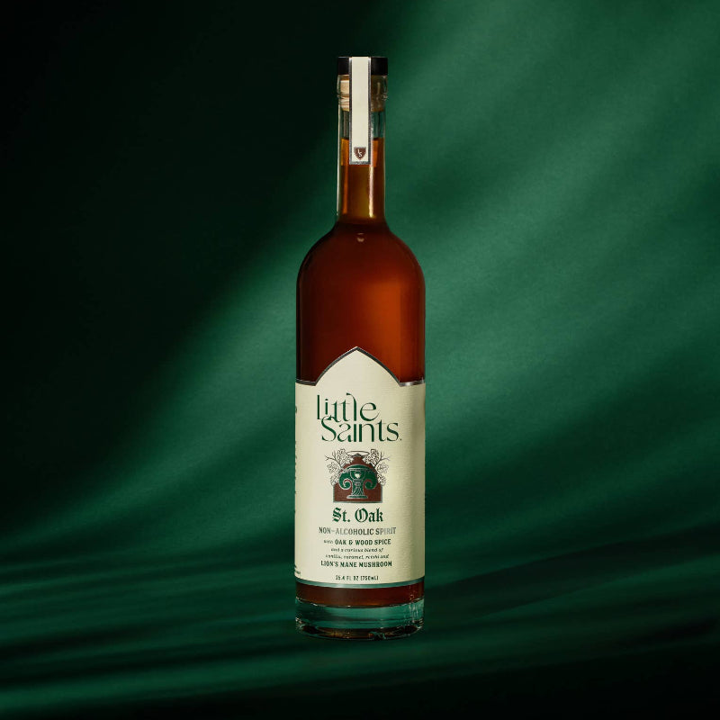Bottle of Little Saint's St. Oak whiskey on a green background