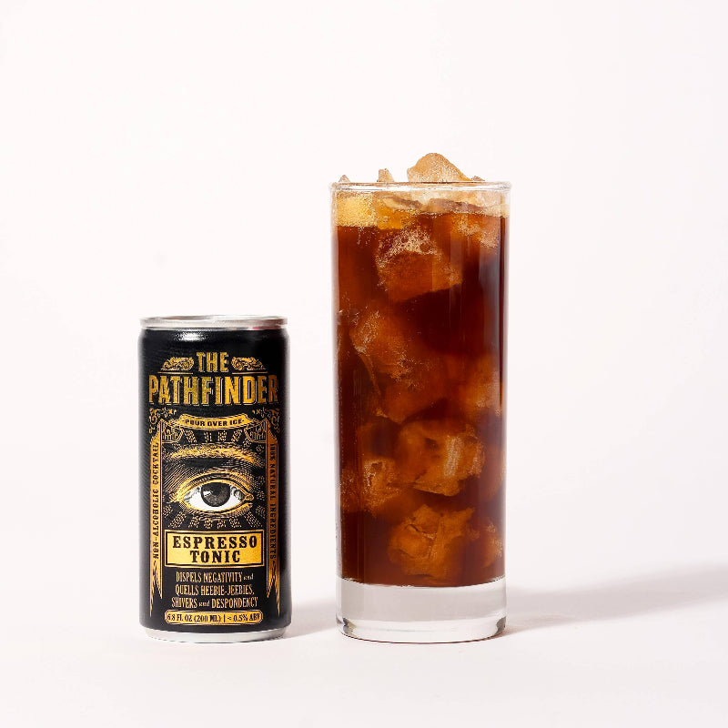 Can of 'The Pathfinder Espresso Tonic' next to a glass of iced coffee on a white background